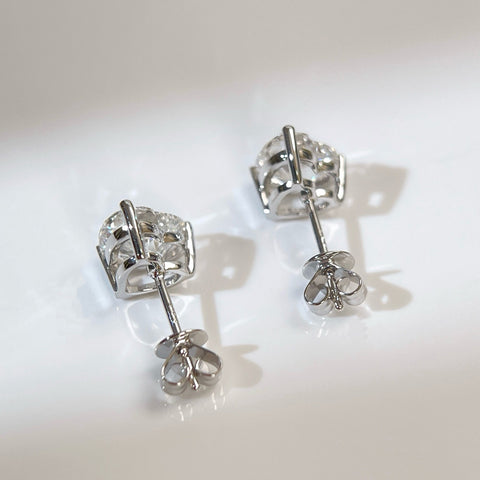 Back view of 18K white gold heart-shaped diamond stud earrings with push backs