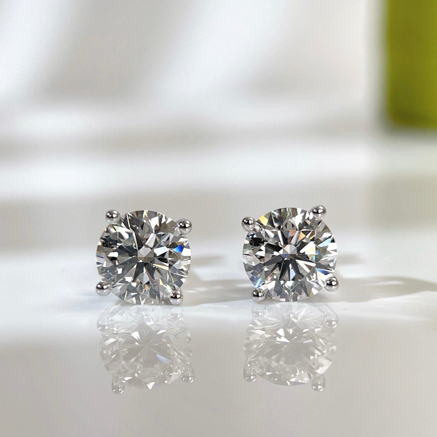 IGI certified 3 CTW round lab grown diamond four-prong stud earrings in 18K white gold