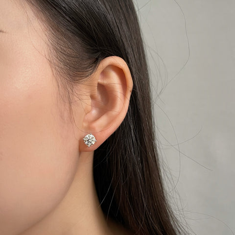 Close-up of a model wearing a 1.5 carat round lab grown diamond stud earring