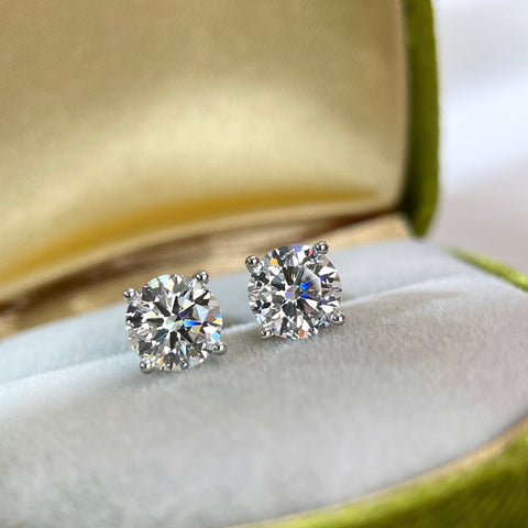 3 CTW round lab grown diamond four-prong stud earrings displayed in a jewelry box