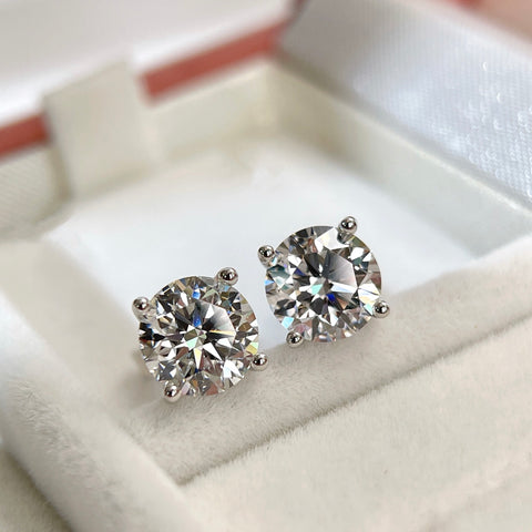 Angled display view of 3 CTW round lab grown diamond four-prong stud earrings