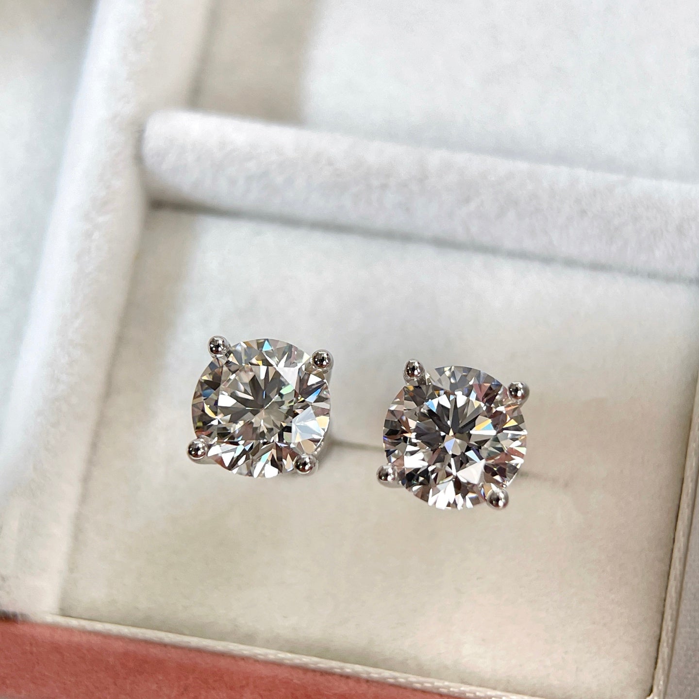 Close-up jewelry box view of 1.5 carat round lab grown diamond stud earrings