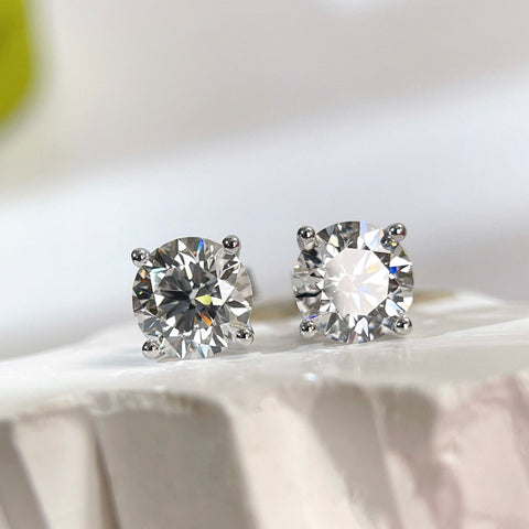 Bright front view of round lab grown diamonds in classic four-prong settings