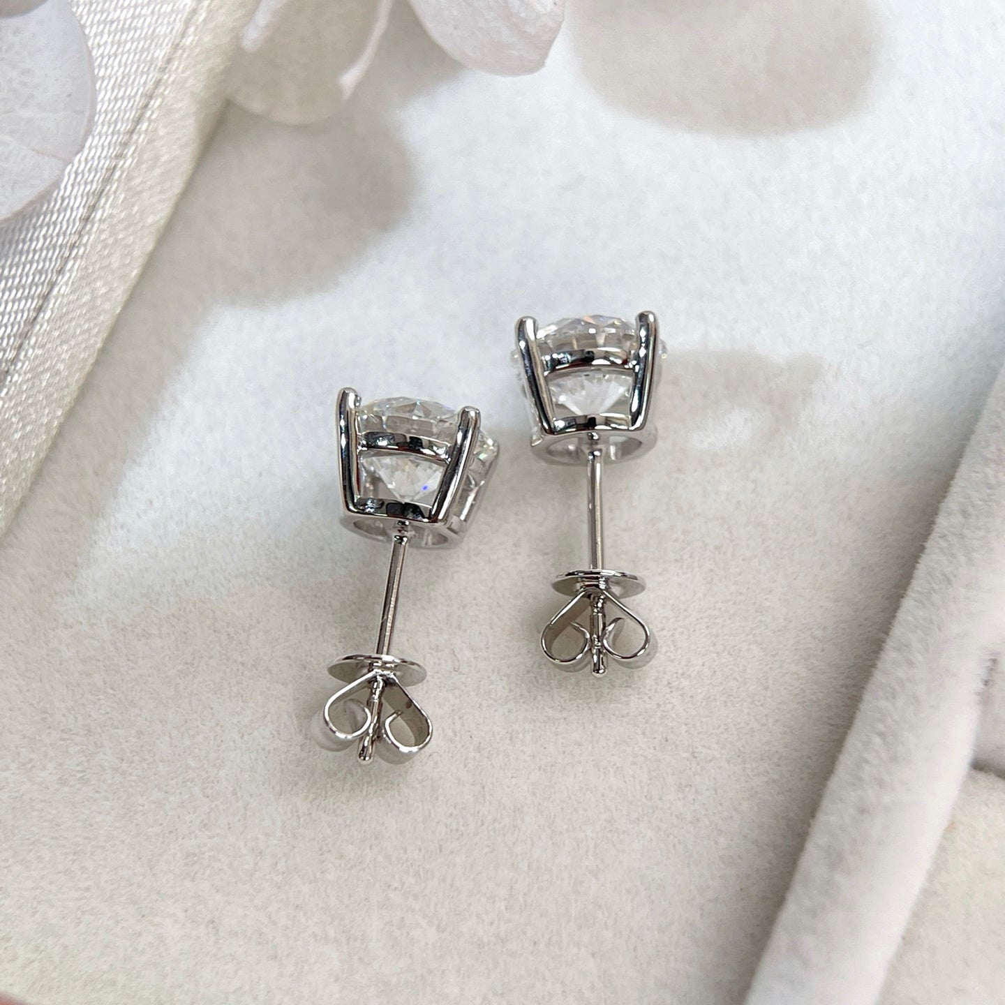 Back view of 18K white gold four-prong stud earrings with push backs