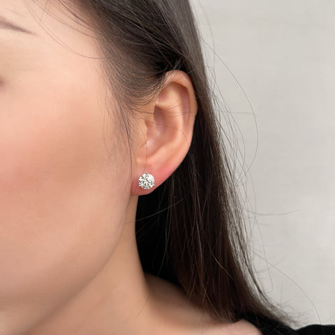 Close-up of a model wearing a 1.5 carat round lab grown diamond Martini stud earring