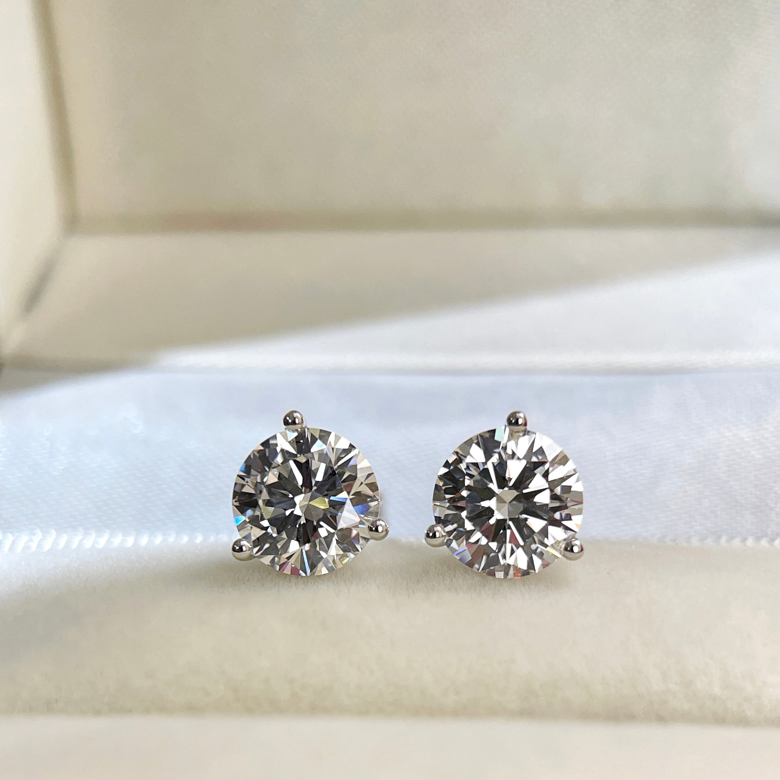 3 CTW round lab grown diamond Martini stud earrings displayed in a jewelry box
