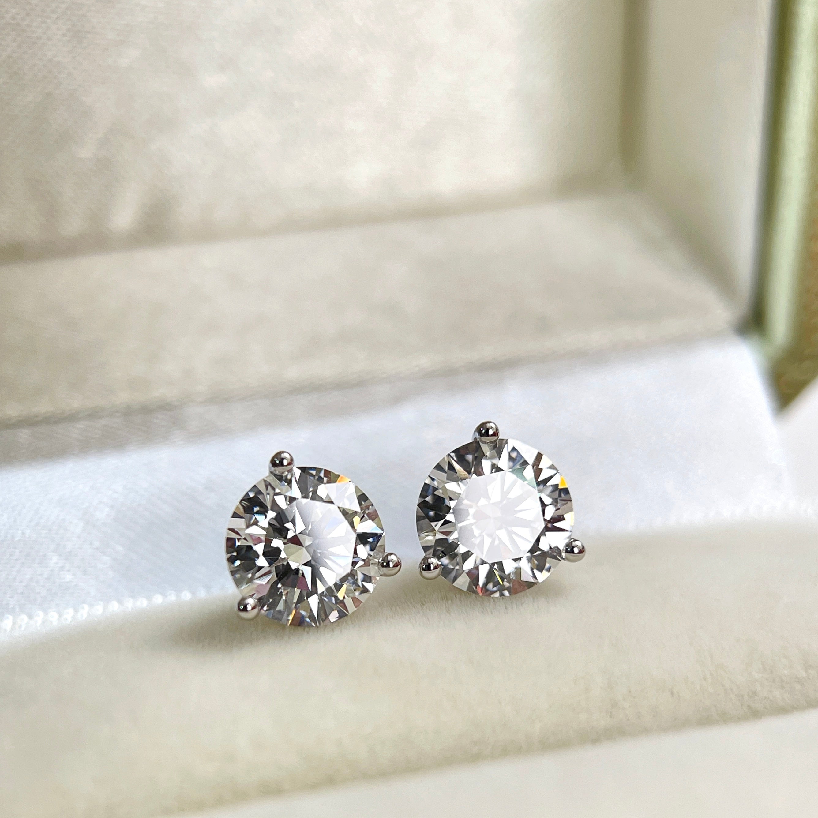 Lifestyle display of IGI certified round lab grown diamond stud earrings