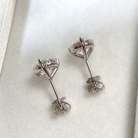 Back view of 18K white gold three-prong Martini stud earrings with push backs